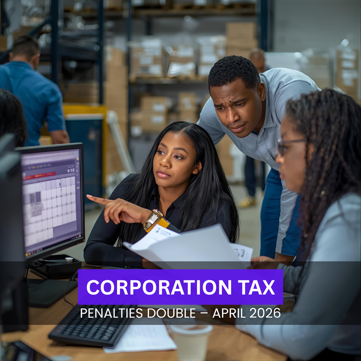 Black British logistics office staff reviewing tax deadlines and HMRC documents at a desk in a UK warehouse office.