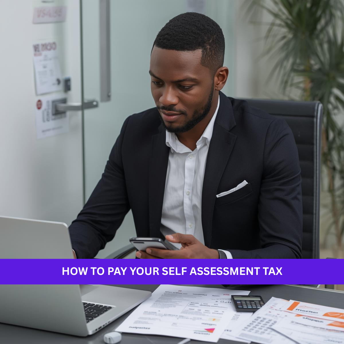Black British professional paying a Self Assessment tax bill online using a laptop and smartphone.
