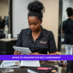 Black British beauty professional checking Self Assessment registration details on a tablet in a salon.